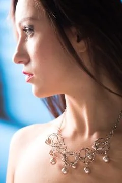 Necklace on the neck. ruby and emerald Stock Photos