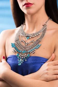 Necklace on the neck. ruby and emerald Stock Photos