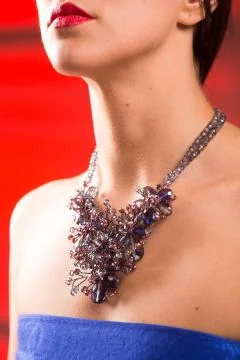 Necklace on the neck. ruby and emerald Stock Photos