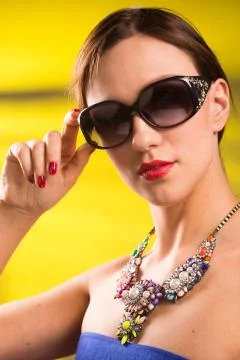 Necklace on the neck. ruby and emerald Stock Photos