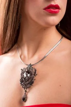 Necklace on the neck. ruby and emerald Stock Photos