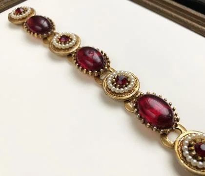 Necklace with red ruby on a white background, close-up 写真素材