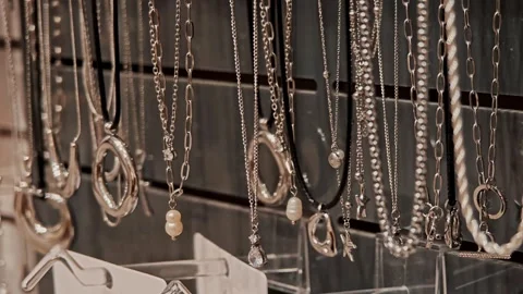 Necklaces with dark decorative elements and stones on exhibition stand. Jewelry Vídeos de archivo 330789571