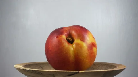 Nectarine fruit rotates on plate in 4K Stock Footage 138685144