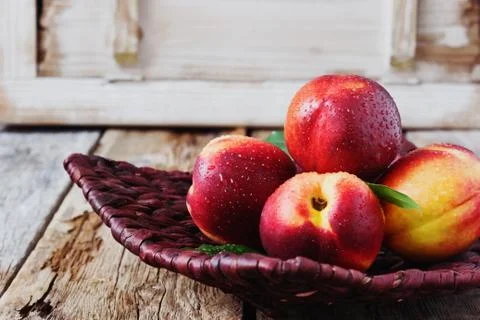 Nectarine in a wicker plate Stock Photos