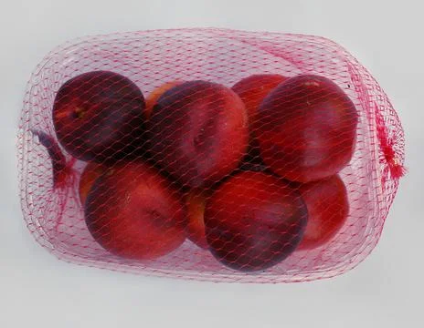 Nectarines in a plastic box Stock Photos