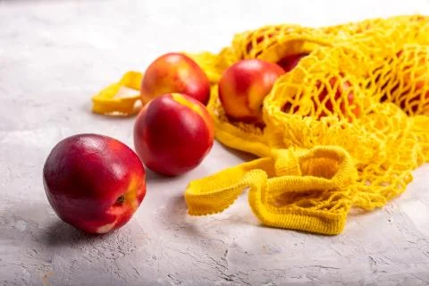 Nectarines in yellow string bag Stock Photos