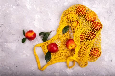Nectarines in yellow string bag Stock Photos