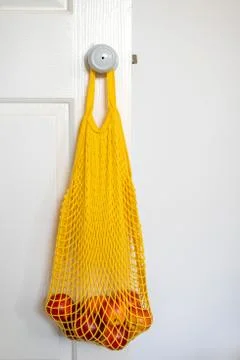 Nectarines in yellow string bag Stock Photos