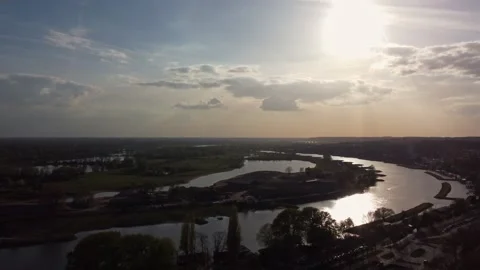 Nederrijn river with flood control system and KEMA Tower in Arnhem sunset aerial Stock Footage 334583897
