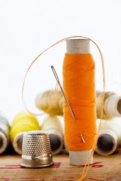 Nedle with orange color thread Stock Photos