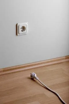 Need extension. White power socket on beige wall at low height from the floor Foto stock