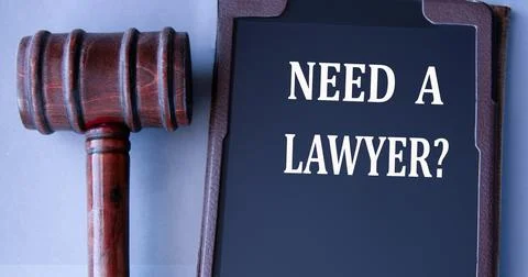 NEED A LAWYER? - words on an electronic notepad with a judge's gavel in the.. Stock Photos