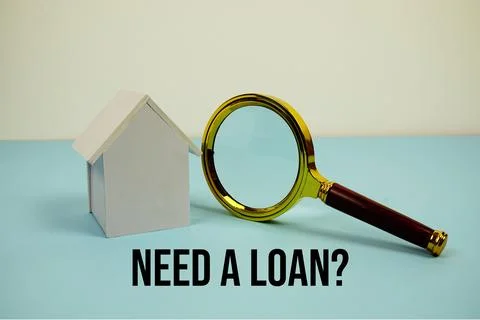 Need a Loan? text with White Model House and magnifying glass on blue backg.. Foto stock