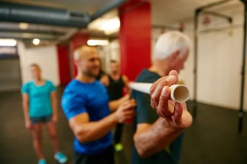 Need to work on your back. a senior man doing pvc pipe exercises with the Stock Photos
