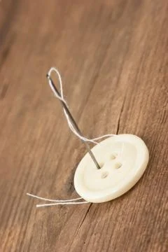 Needle and a button 스톡 사진
