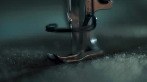 Needle and foot of the sewing machine penetrates in high zoom and slow motion. Stock Footage 179711431