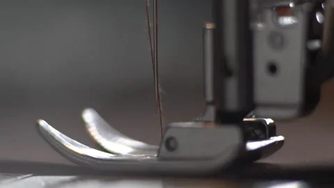 Needle and foot of sewing machine making stitches macro Stock Footage 195956843