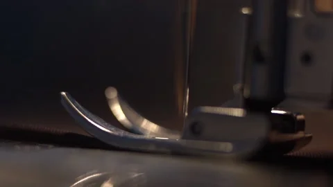 Needle and foot of sewing machine making stitches macro Stock Footage 196016834