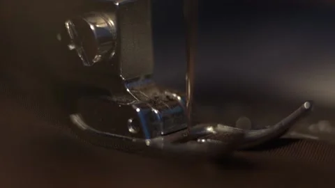 Needle and foot of sewing machine making stitches macro Stock Footage 196016862