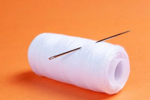 Needle and sewing thread sew Stock Photos