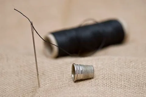 Needle and thimble. Stock Photos