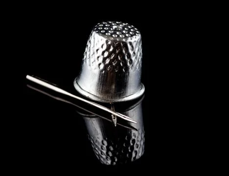 Needle and thimble Stock Photos