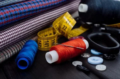 Needle and thread. Scissors and cloth. Stock Photos