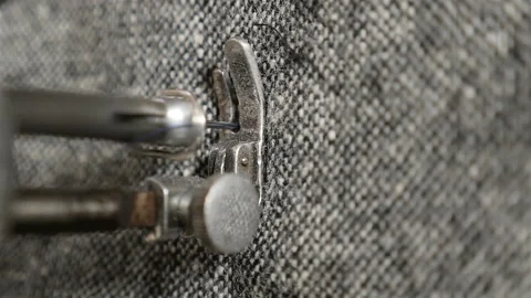 Needle and thread in a sewing machine. Sewing of clothes. Slow motion. Close-up Stock Footage 88930341
