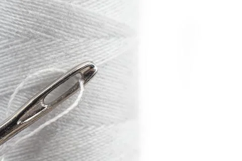 Needle and thread on a white background close-up. Needle isolate with empty.. Stock Photos