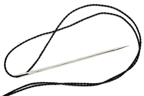 Needle and thread on a white background Stock Photos