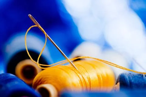 Needle and yellow thread Stock Photos