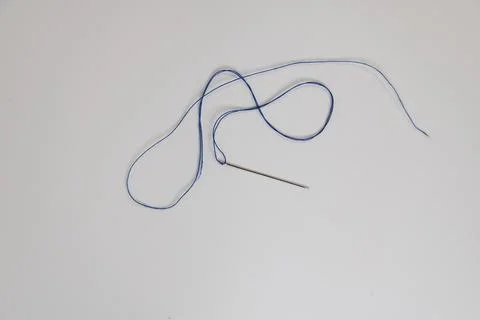 Needle with blue thread Stock Photos