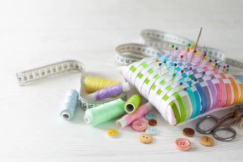 Needle box, threads and cotton fabrics for sewing. White background. Stock Photos
