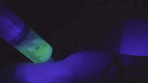 Needle with Fluorescent Liquid Stock Footage 234210823