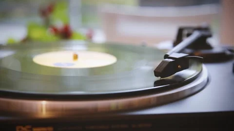The needle goes down on a vintage vinyl record. The vinyl record is spinning Stock Footage