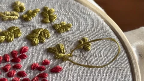 Needle, hands and thread close-up, process of embroidering oak leaves Stock Footage 319856831