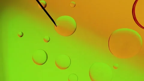 Needle makes a drop on a yellow-green gradient background. Vídeo Stock 303058862