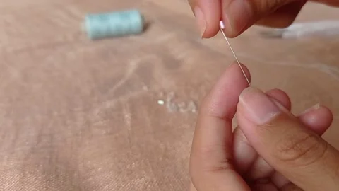 Needle for making clothing with a blue thread Stock Footage 146248782