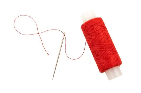 Needle with multi-colored threads on a white background. Eye of a needle cl.. Foto stock