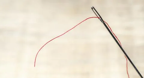 Needle with red thread Stock Photos