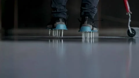 Needle roller on the self-leveling floor. Leveling with a mixture of epoxy Stock Footage 150875075