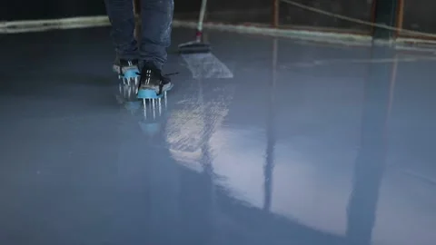 Needle roller on the self-leveling floor.Leveling with a mixture of epoxy floors Stock Footage 150875047