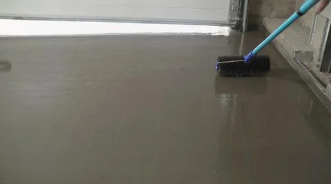 Needle roller for self-leveling floors. Leveling the floors with a cement mix Stock Photos