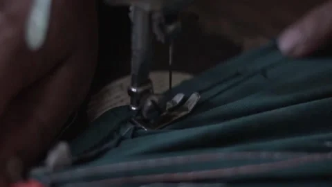 Needle of sewing machine with women's hand close-up of the needle slow motion Stock Footage 130852566