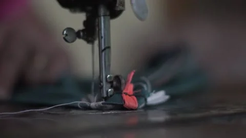 Needle of sewing machine with women's hand close-up of the needle slow motion Video stock 130854370