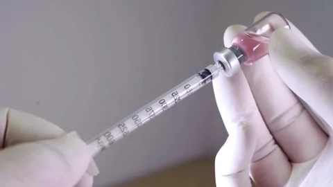 Needle Syringe getting ready for injection for vaccination a doctor takes a Stock-Footage 336586989