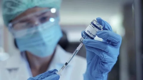 Needle Syringe getting ready for injection for vaccination a doctor takes a Stock-Footage 336587113