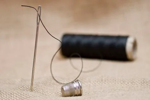 Needle, thible and thread. Stock Photos