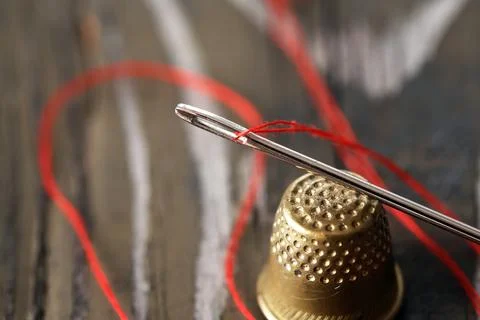 A Needle With Thread And A Thimble Stock Photos